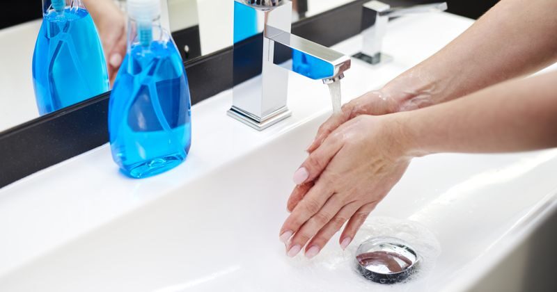 Washing hands in commercial bathroom