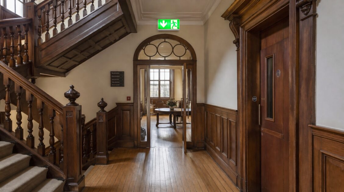 Heritage building interior with modern fire safety features integrated into traditional architecture.