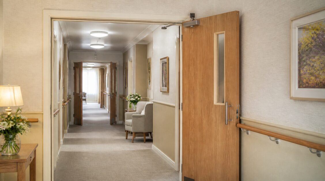 UK care home corridor with fire doors and clear escape route